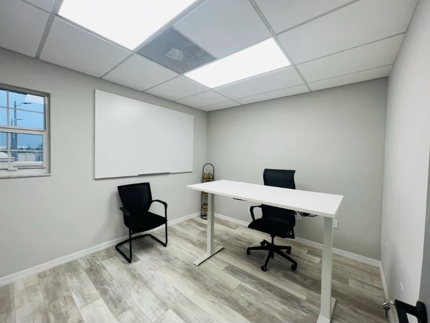 Private office with sit-stand desk and whiteboard