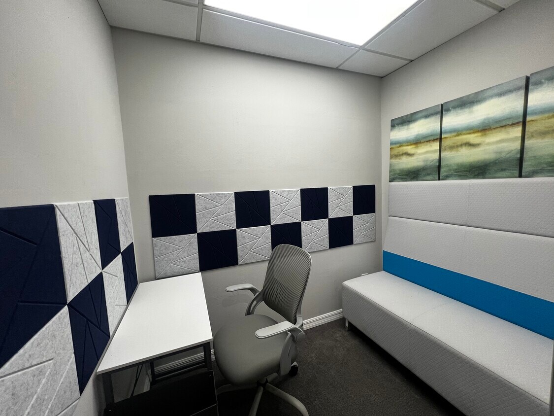 Podcast room with acoustic panels, desk and bench seating